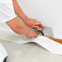 7) Trim neatly at the ceiling and floor using bladed knife and straight edge