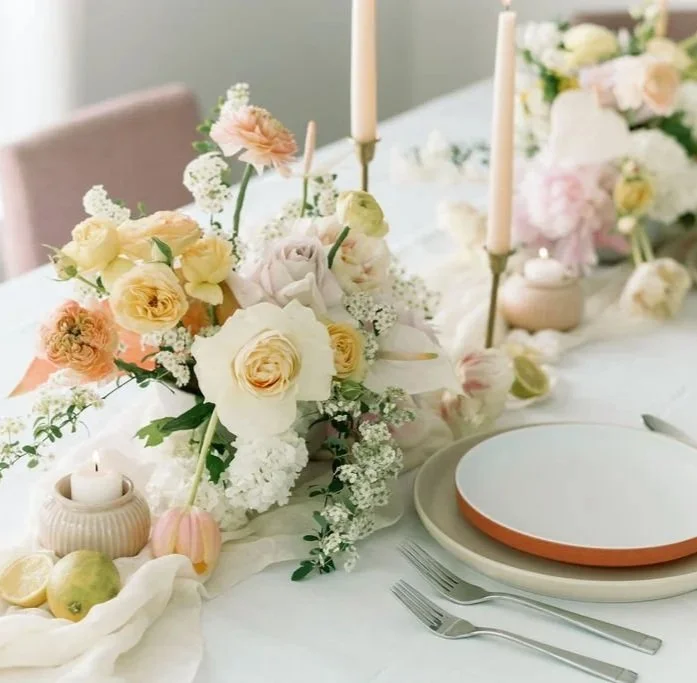 Elegant, luxury table setting with a pastel floral centerpiece