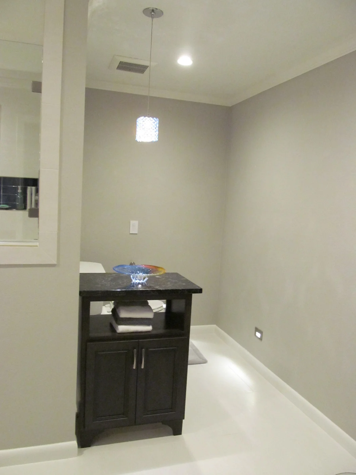 The cabient hiding the toilet is able to be moved, should the clients need it to b.JPG