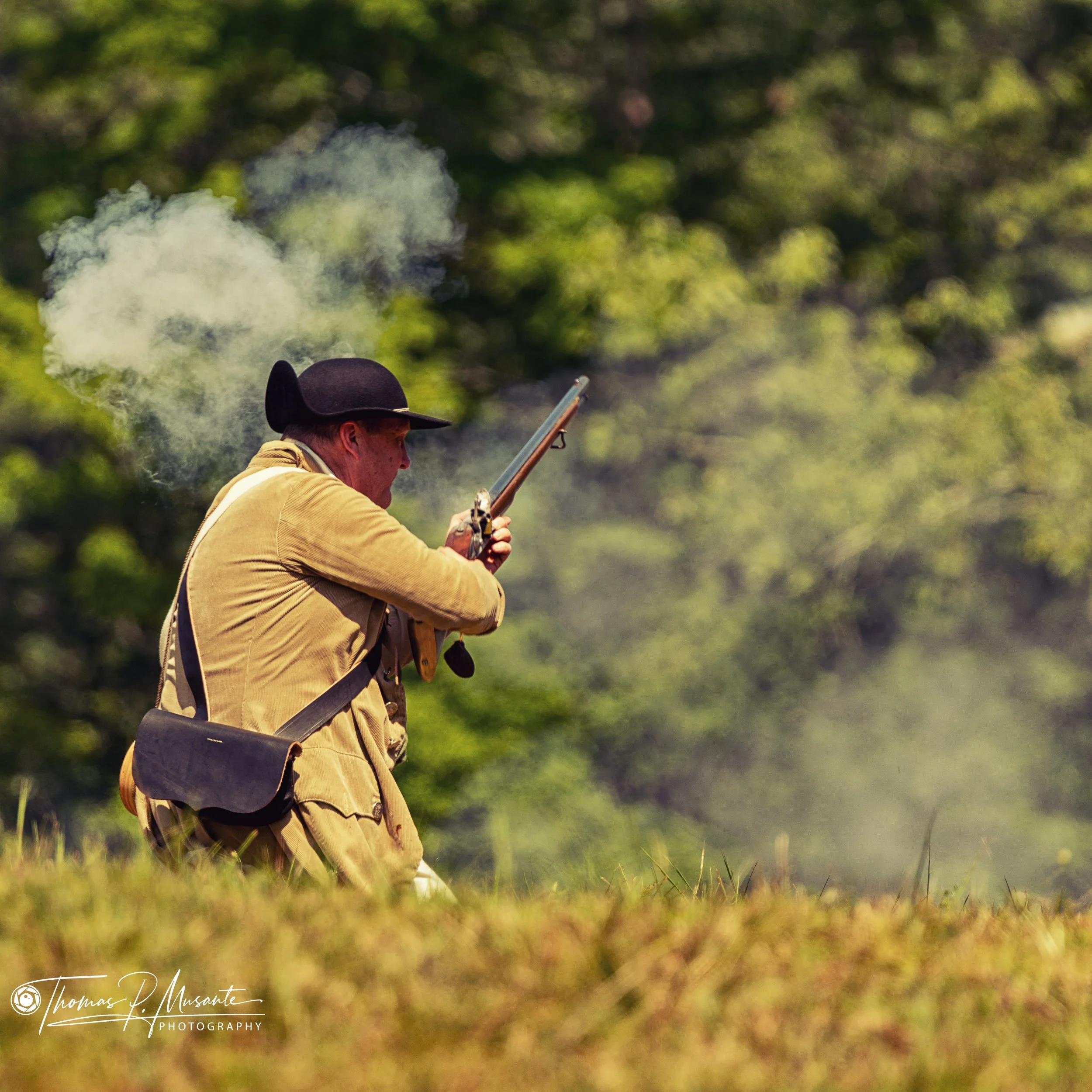 A Reenactor Works His Flintlock After the Shot