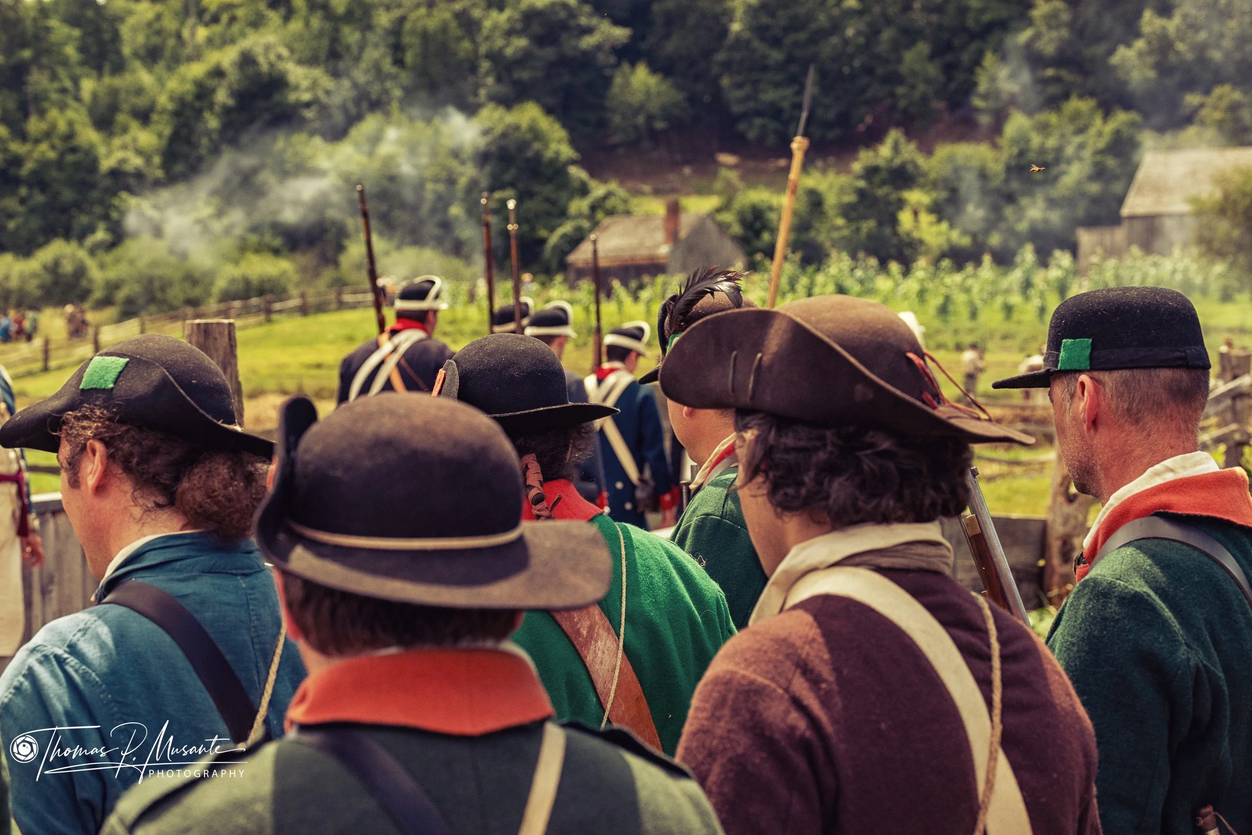 Upright Flintlocks in the Ranks as Smoke Drifts Along the Treeline