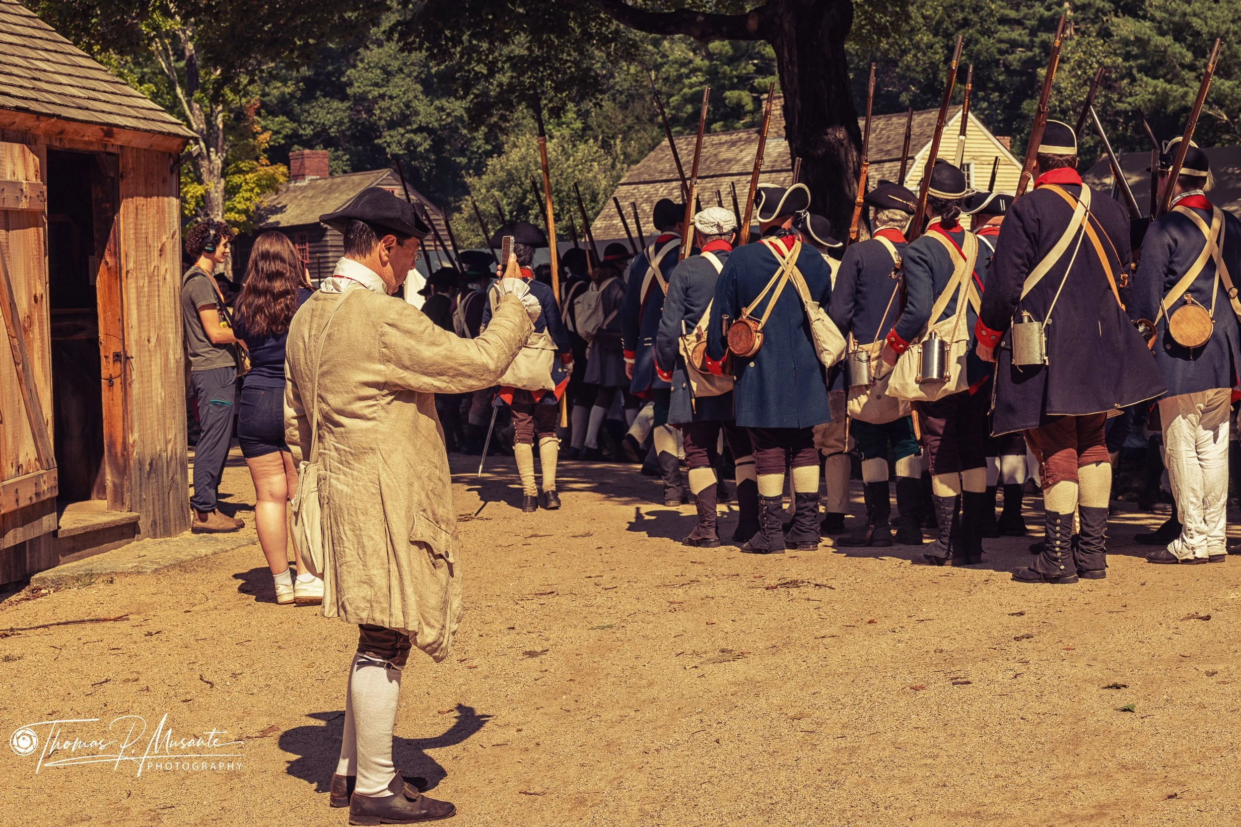 A Costumed Interpreter Photographs the Marching Column on His Phone