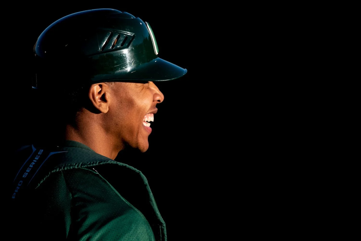  Ohio catcher Devonte Washington is illuminated by a beam of sunlight in the dugout during the Ohio versus Ohio State game at Bob Wren Stadium in Athens, Ohio, on April 19, 2019. The Bobcats lost the back-and-forth match 10-8. 