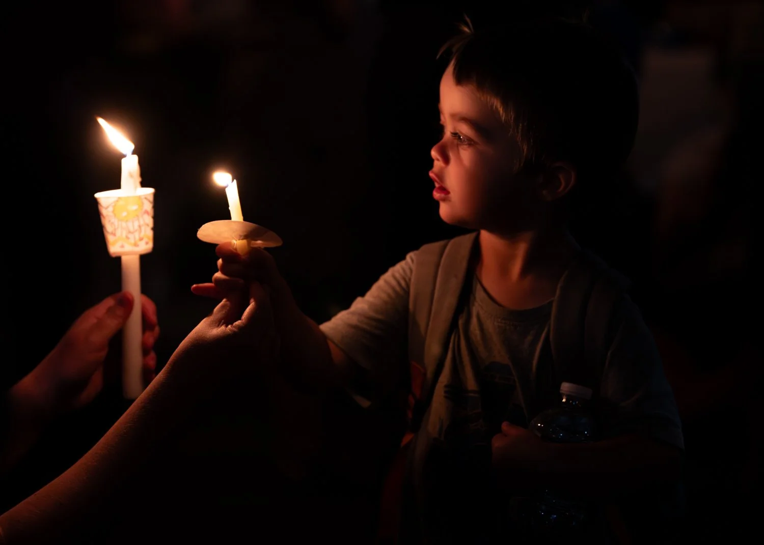  Garrett Michael, 2, holds a candle during a vigil at the conclusion of the 2019 Interfaith Peace Walk in Athens, Ohio, on Sept. 11. Beginning at Ohio University’s Interfaith Chapel and ending at the Islamic Center of Athens, the walk is held annuall