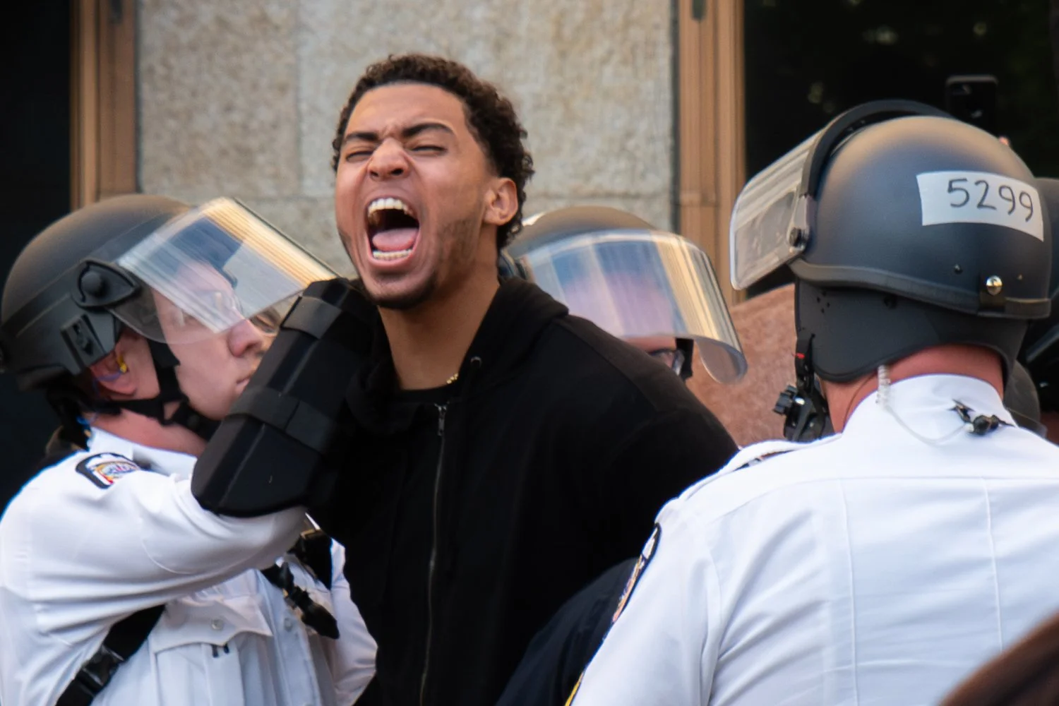  Ohio State University men’s basketball player Seth Towns is detained by police during a protest in downtown Columbus, Ohio, on May 29, 2020. The protest was held in response to the murder of George Floyd by white police officers on May 25 in Minneap