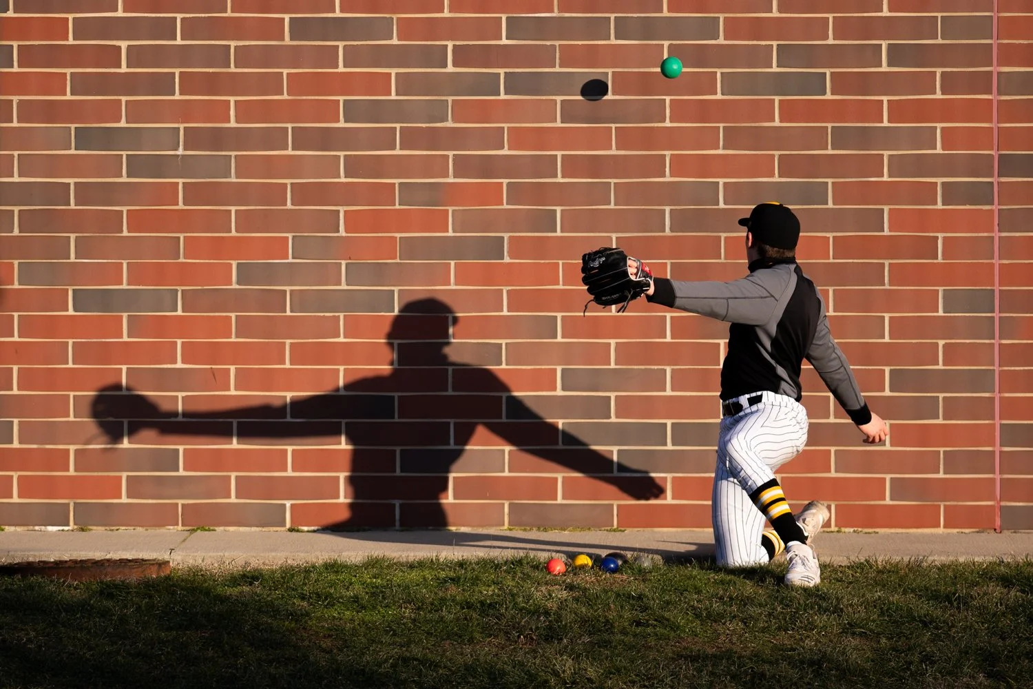 A Wisconsin-Milwaukee baseball player warms up during Milwaukee’s 14-3 loss to the Ohio Bobcats at Bob Wren Stadium in Athens, Ohio, on March 5, 2021. 