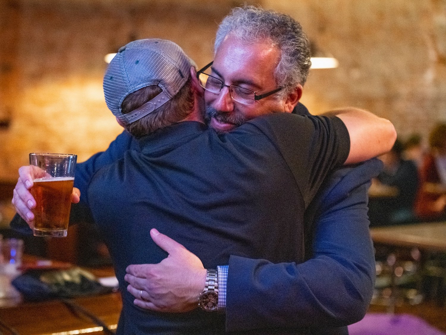  Chris Roach (left) hugs Ric Wasserman (right) at the Pigskin Bar and Grille in Athens, Ohio, after Athens County’s vote totals were announced on Nov. 6, 2018, in Athens, Ohio. Wasserman (D) won election to Athens County Treasurer in the 2018 midterm