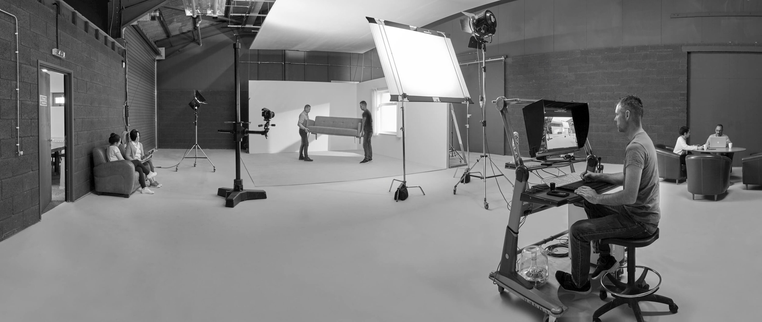 Studio-2-two-moorland-studios-roomsets-photography-setup-hire-space-uk-midlands-man-moving-sofa-on-set.jpg