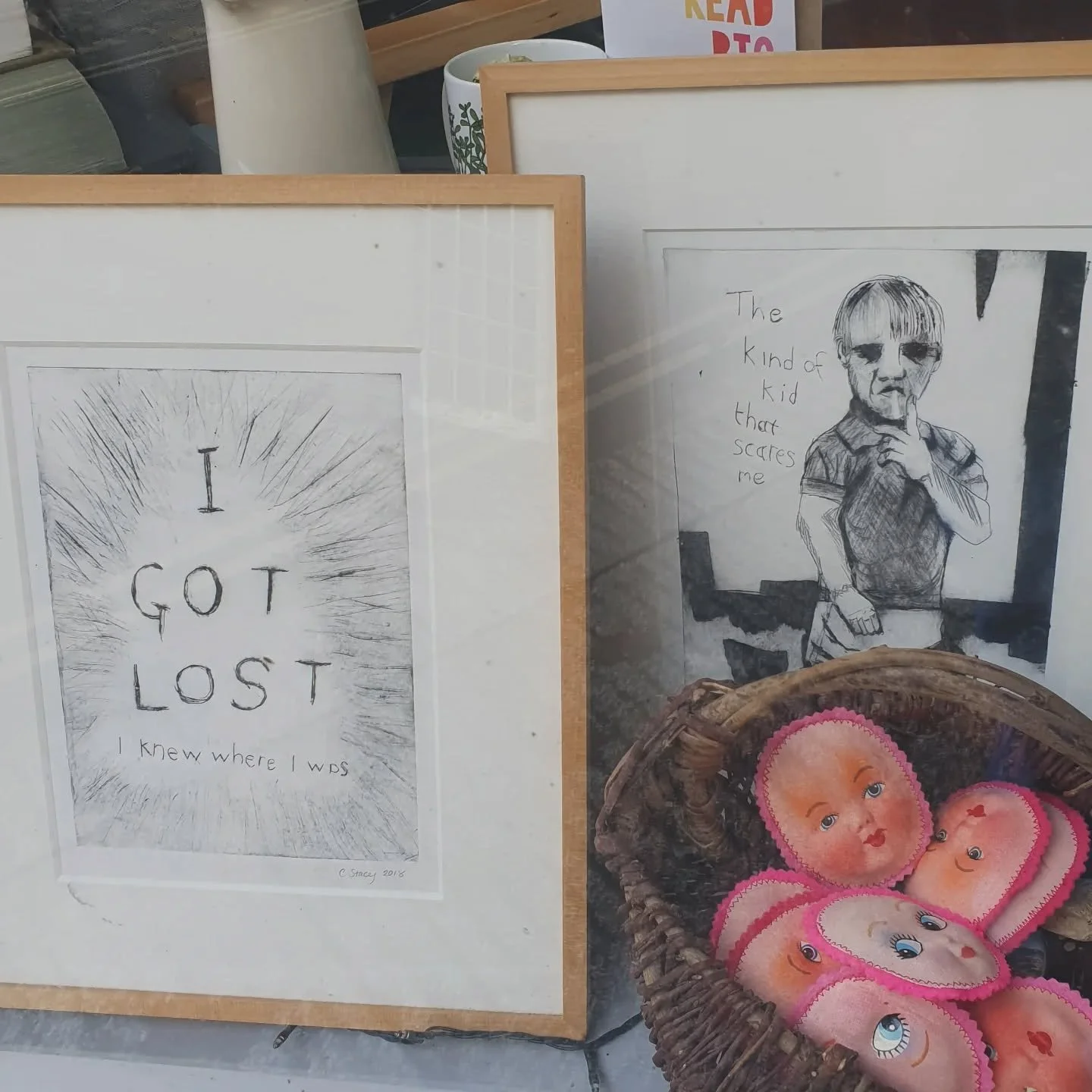 I tried to make a spooky window display but it turned out to just be my art. I have one or two  drypoint prints that would fit in better to the spooky theme but they are on a high shelf and I've already broken/almost broken 3 things today.

Prints ar