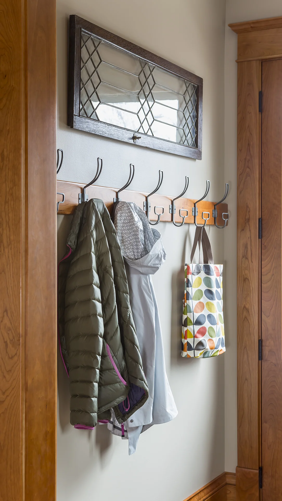 A row of eye-catching hooks gives everyone a place to store their gear.