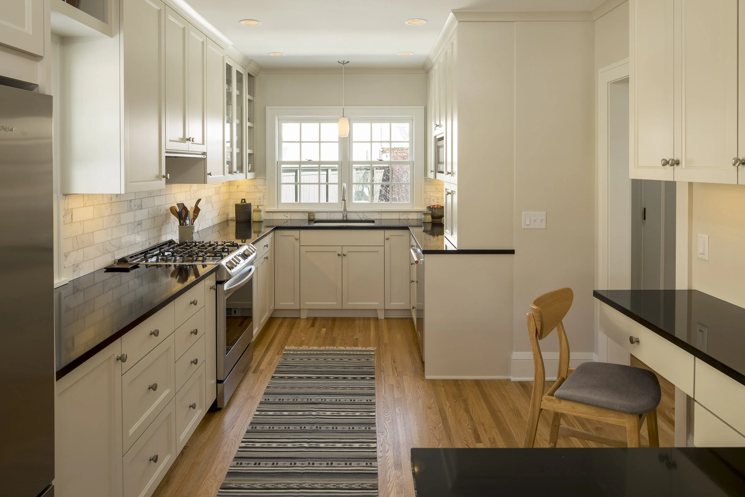 Pale grey cabinets and a reconfigured layout helped open up this kitchen and better connect it to the rest of the home.
