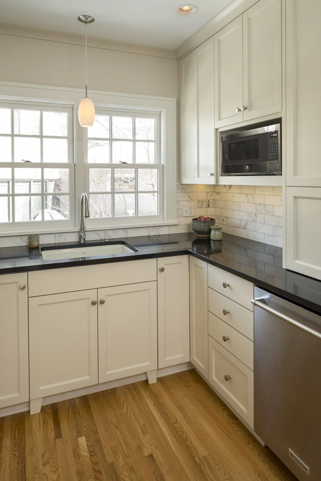 Frameless cabinetry, quartz countertops and a marble-tile backsplash strike just the right balance of old and new.