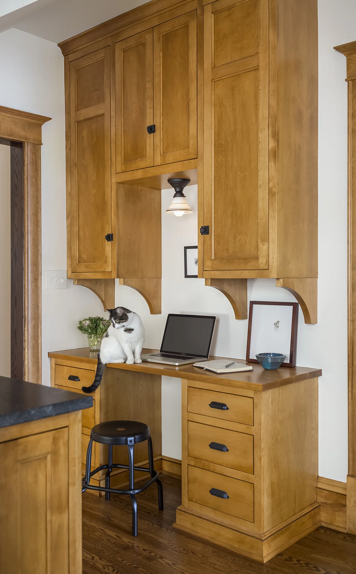 A new desk area and command center was added to the space to minimize clutter and chaos in other areas of the home. Additionally, a new door into the front room was created to ensure ease of flow throughout the first floor.
