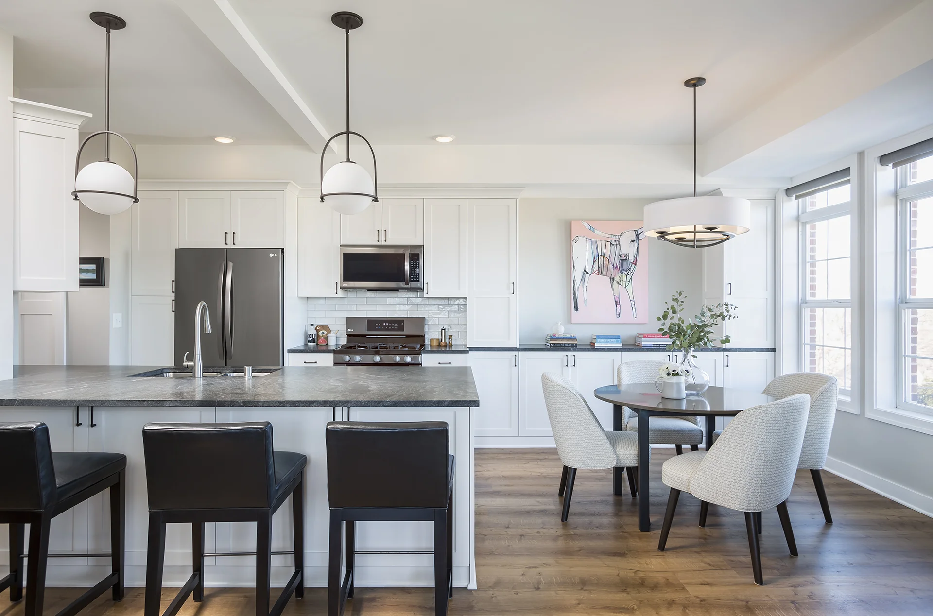 Tons of natural light paired with bright white cabinetry make this smaller kitchen feel airy and spacious.