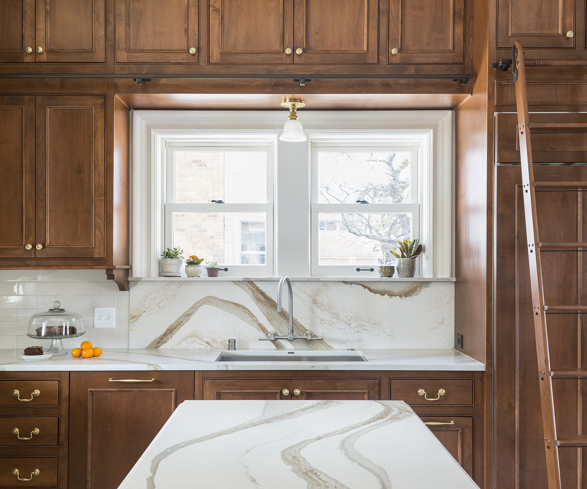Continuing the countertop material on the backsplash creates a stunning focal point in the kitchen and adds continuity.