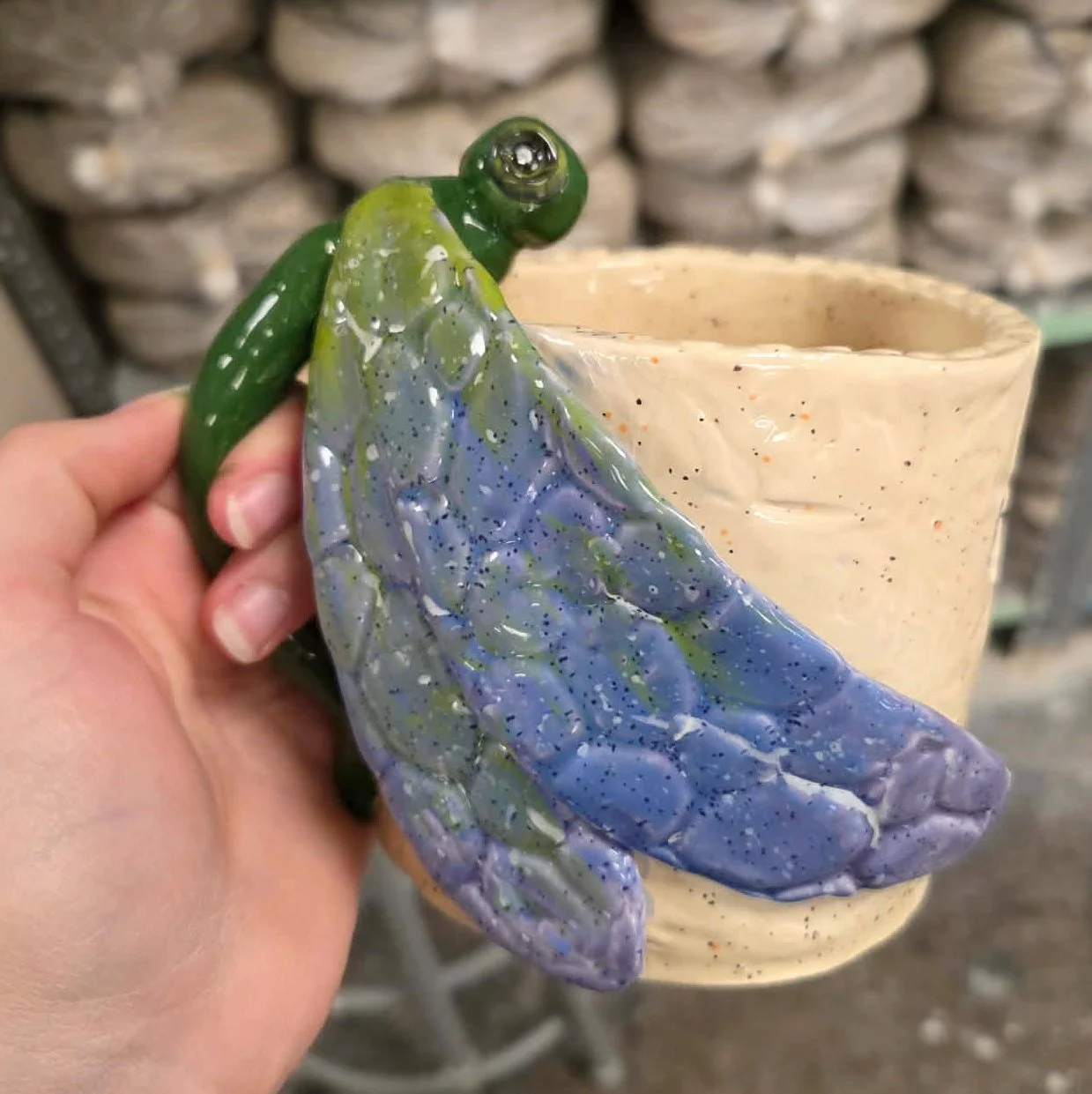 dragonfly mug in hand.jpeg