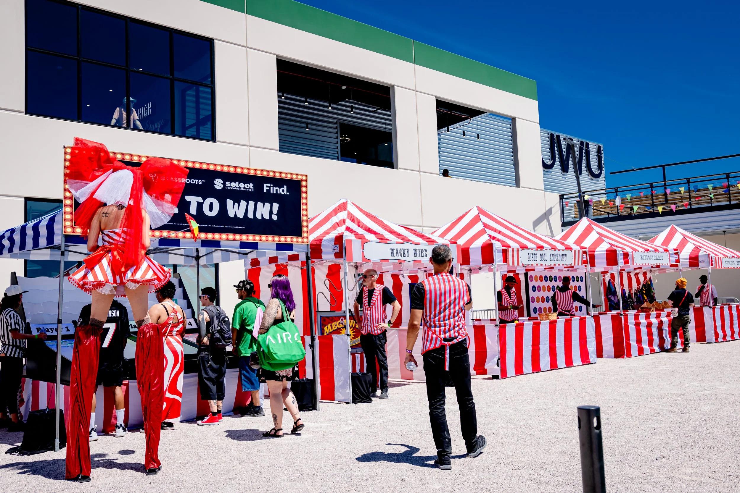 Guests playing carnival games and interacting with performers during the 420 State Fair event outside NuWu Main Dispensary in downtown Las Vegas.