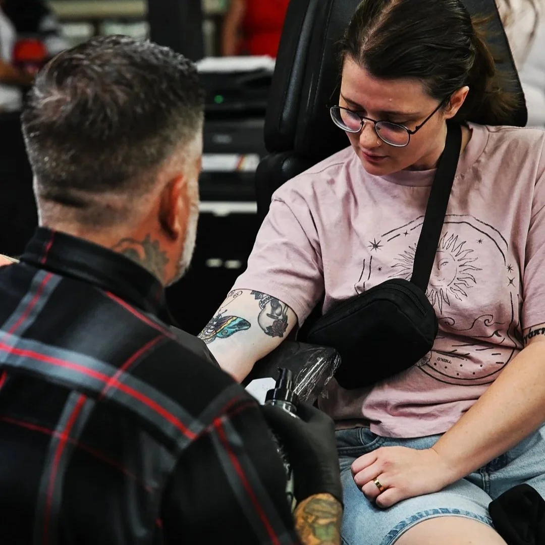 Koolsville Tattoo artist working on a client’s arm at a Las Vegas tattoo shop