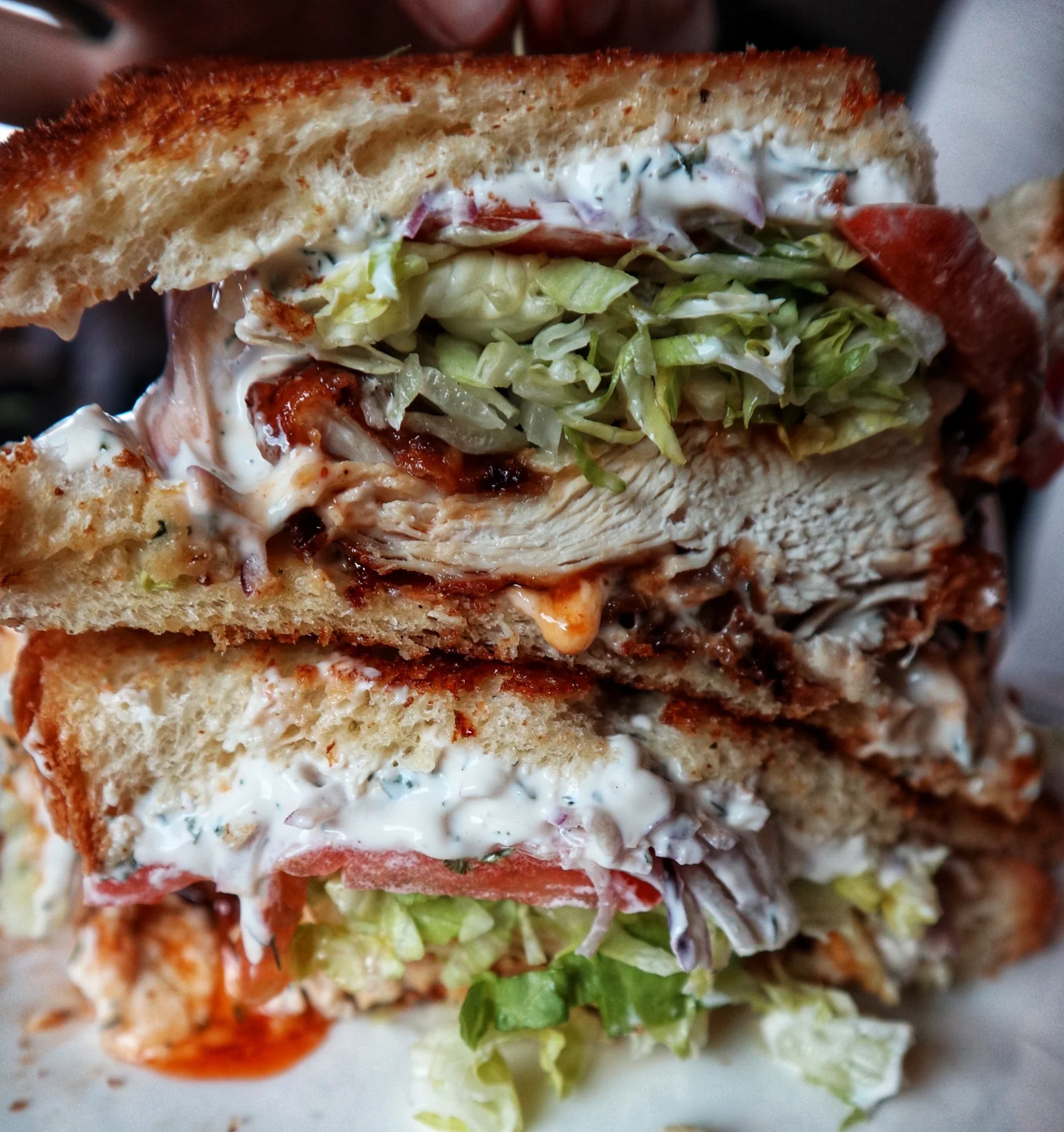 Chicken Sandwich: fried chicken, crystal glaze, LTO, pickles & ranch mayo on lucky cat brioche