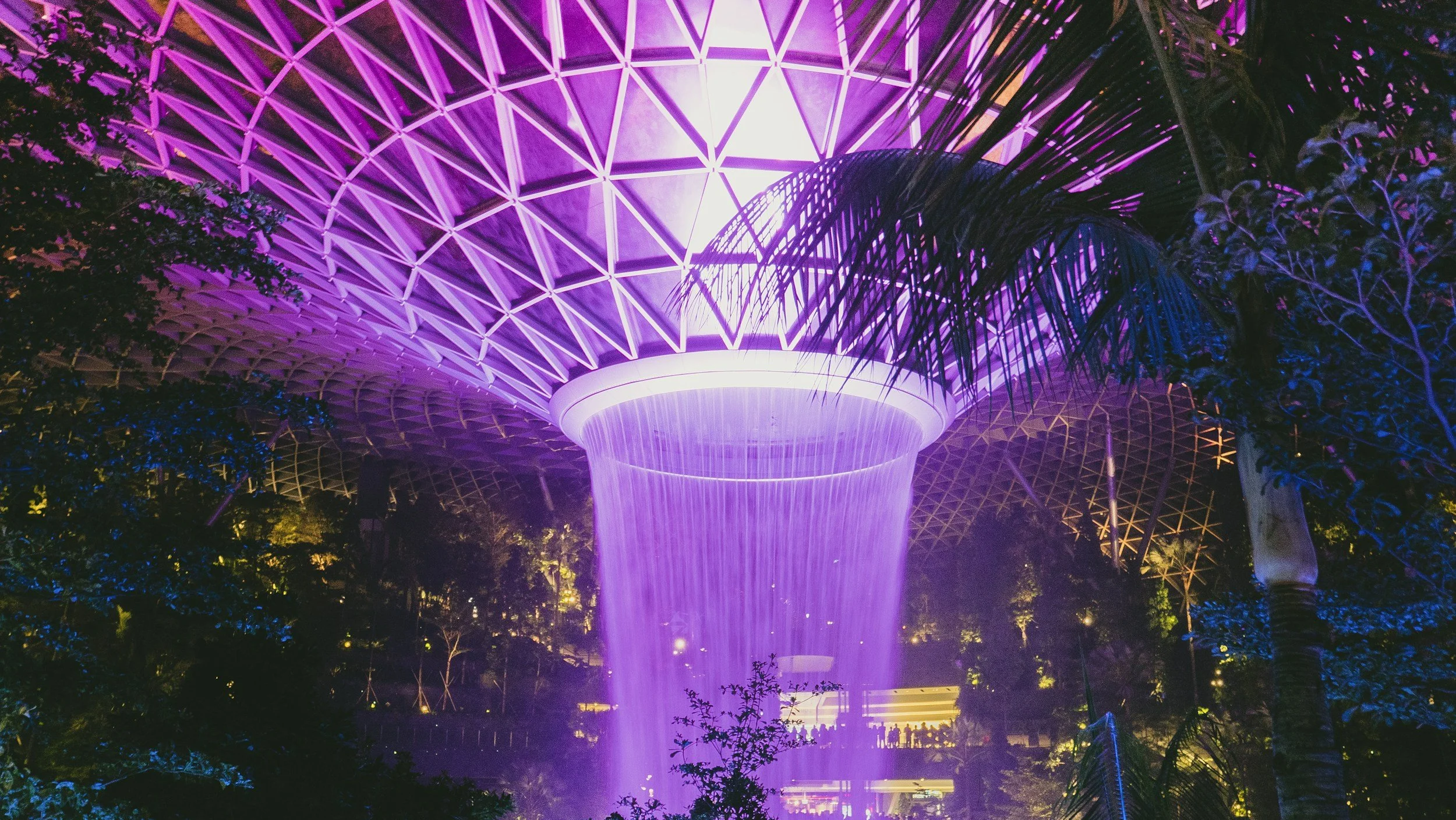 The Rain Vortex at Jewel Changi dazzles visitors with lights and cascading water.