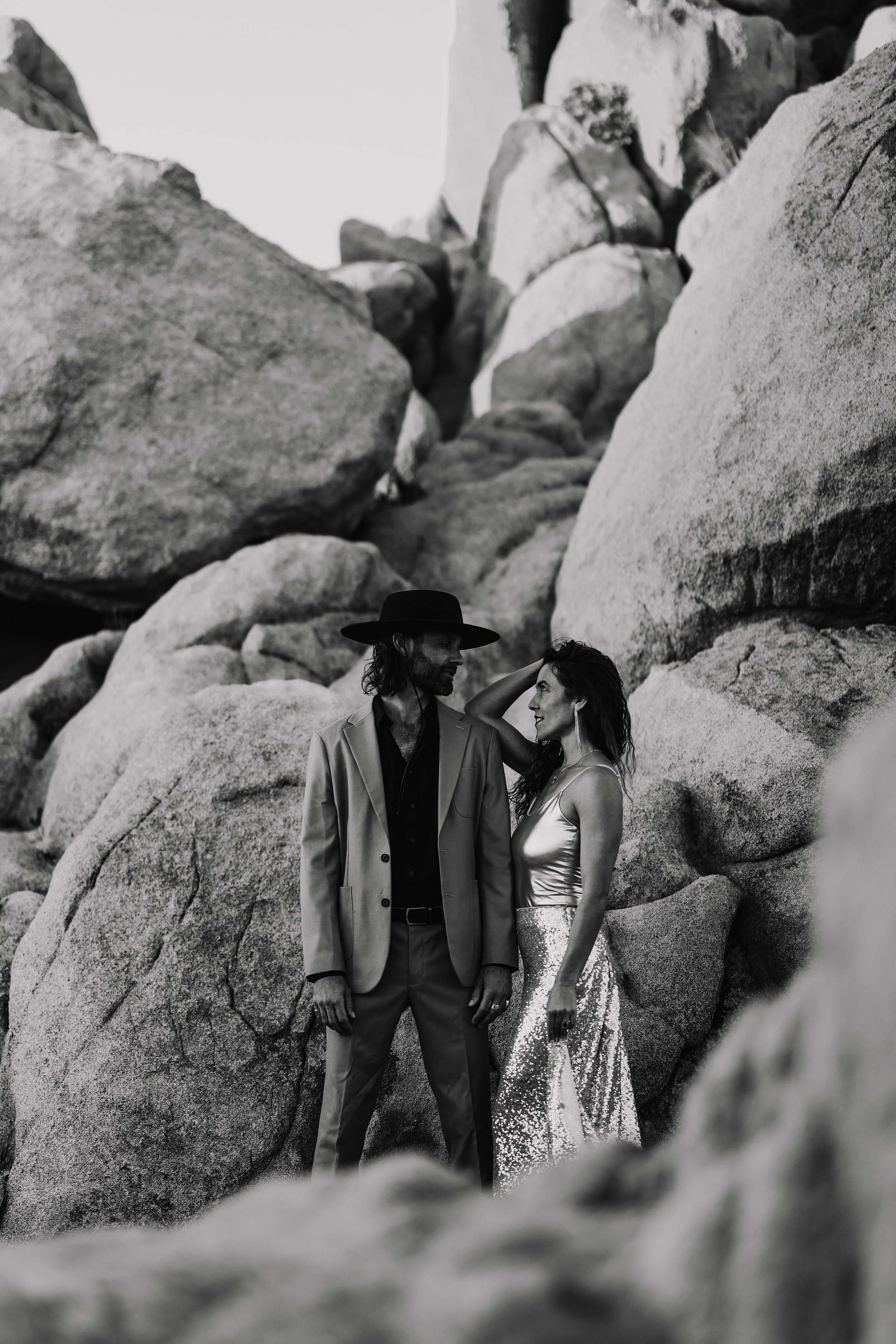 black and white engagement couple shoot in front of rocks