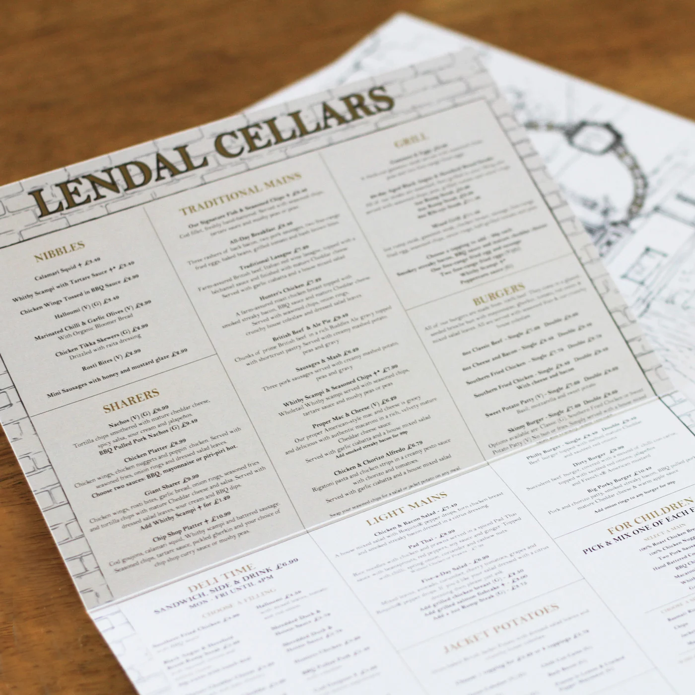 The Lendall Cellars briefed See Speak Hear to design new menus for their traditional, premium pub hidden away underground in the heart of York. This quaint illustration depicts the old metal arch above the walkway to the entrance that leads down into the cosy cellars beneath. This delicate line drawing is used beside a brick pattern and features on the menus. 