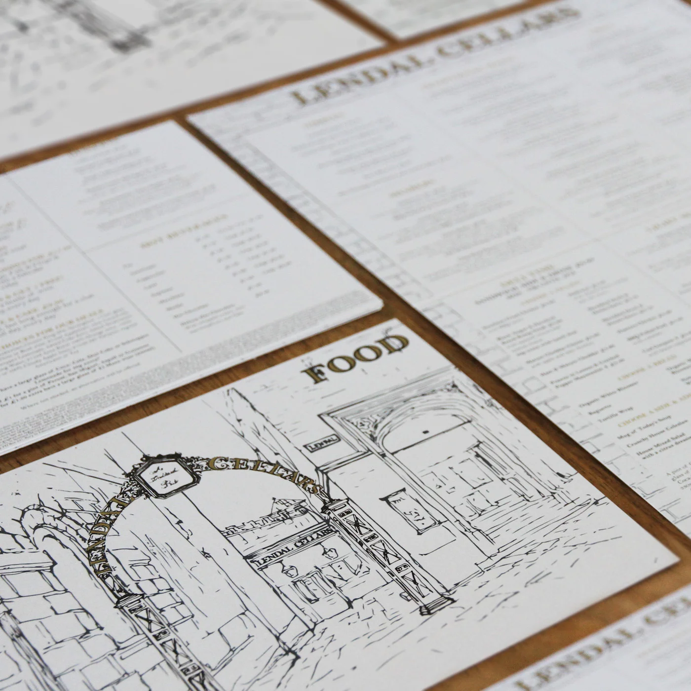 The Lendall Cellars briefed See Speak Hear to design new menus for their traditional, premium pub hidden away underground in the heart of York. This quaint illustration depicts the old metal arch above the walkway to the entrance that leads down into the cosy cellars beneath. This delicate line drawing is used beside a brick pattern and features on the menus. 