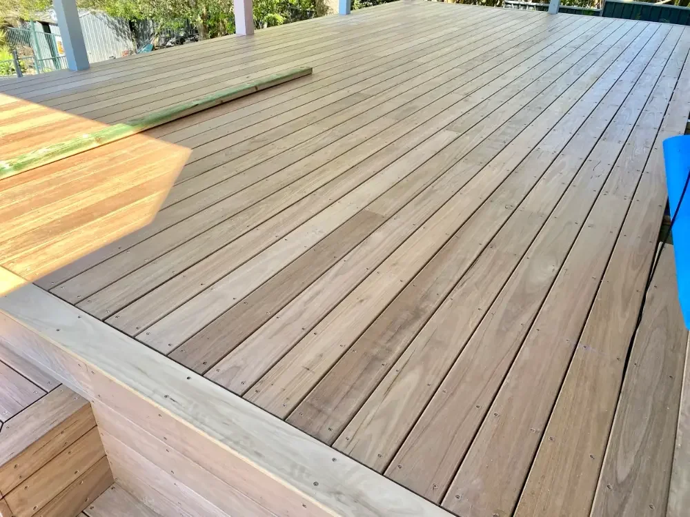 Newly installed timber decking across a large outdoor entertaining area.