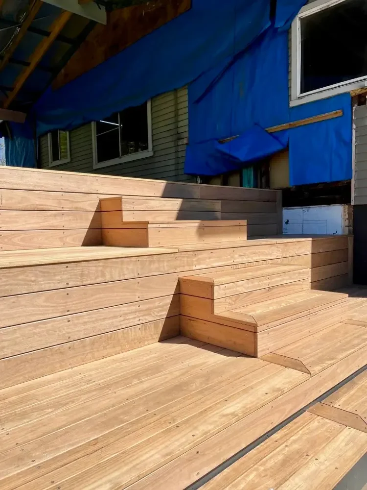 Timber decking with built-in tiered seating and steps.