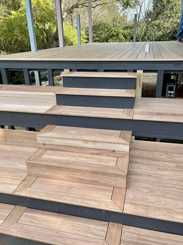 Custom timber deck with integrated wide steps and tiered levels.