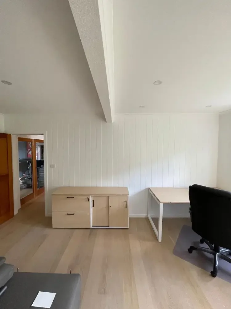 Bedroom with storage cupboards, table and desk chair
