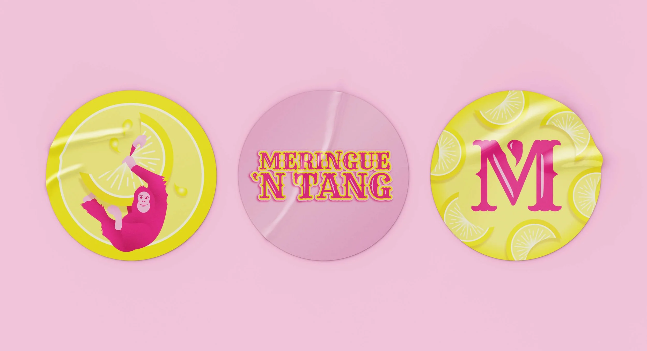 Three round stickers with Meringue 'N Tang branding on a light pink background.