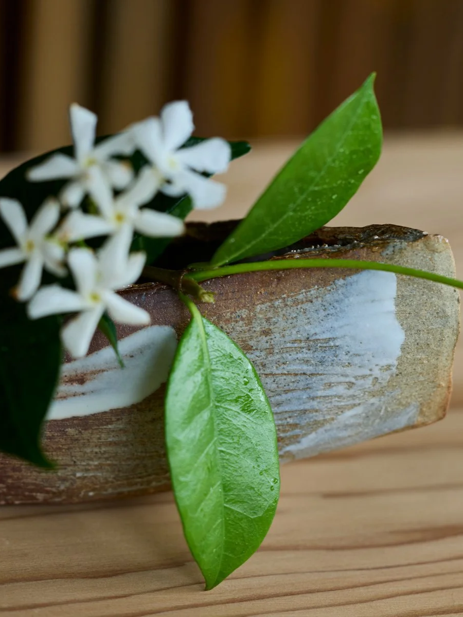  Vessel: 'Setting sail' , Hand built boat-shaped flower container , Porcelain slip and Ash glaze Flower: Jasmine (Summer) Image: Andrew Sikorski
