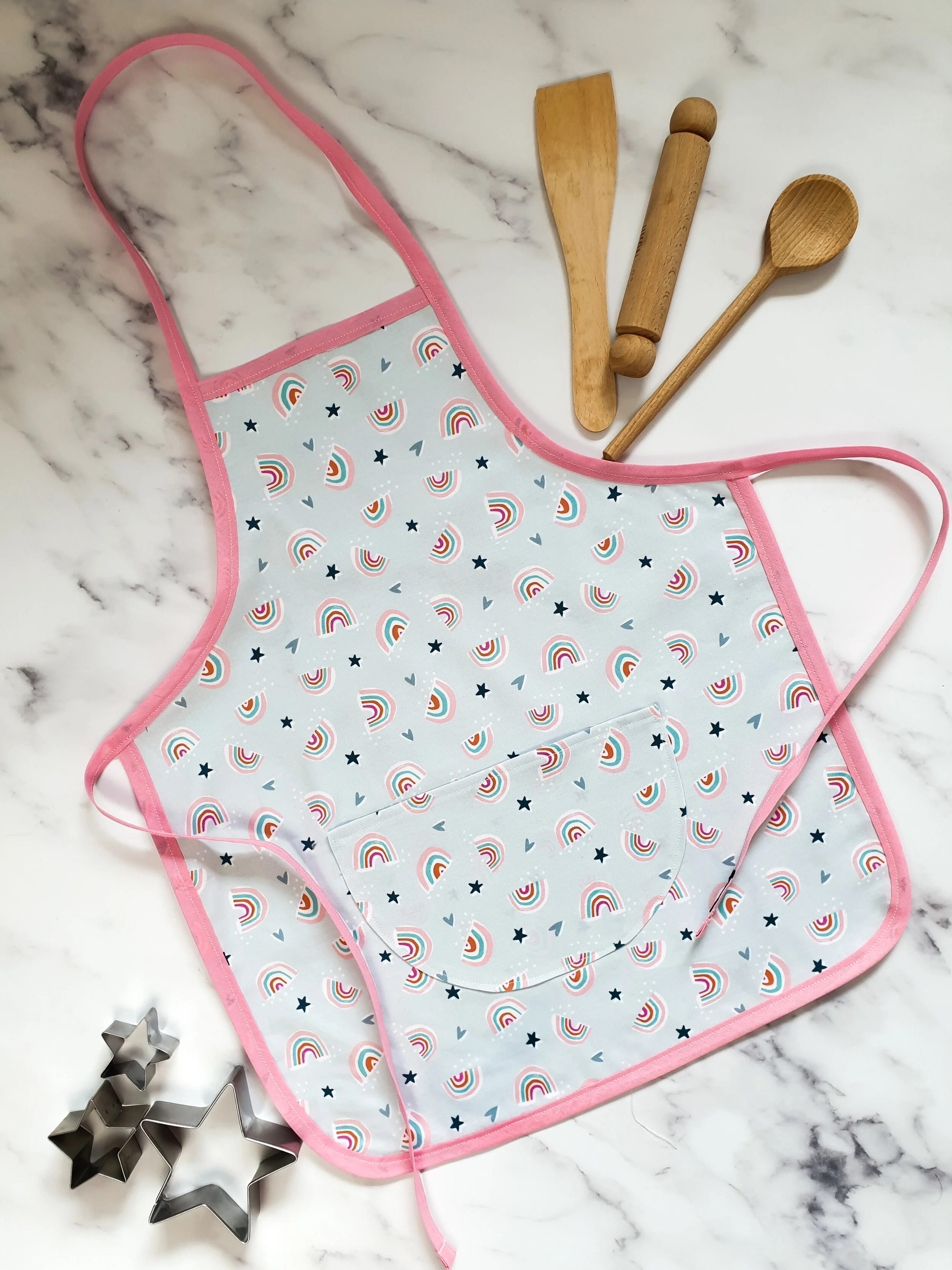 Children's rainbow apron with baking accessories.