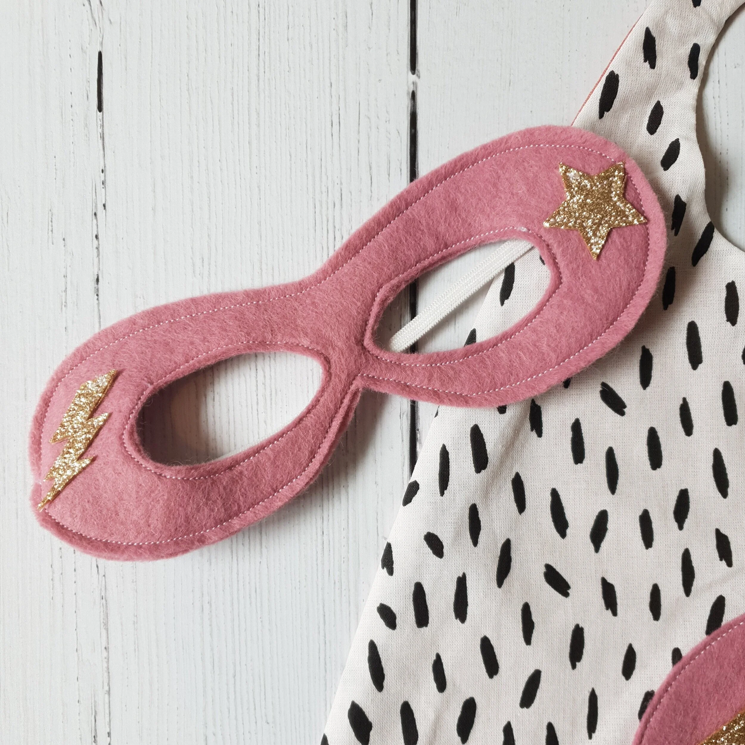 Up close detail of pink superhero mask.