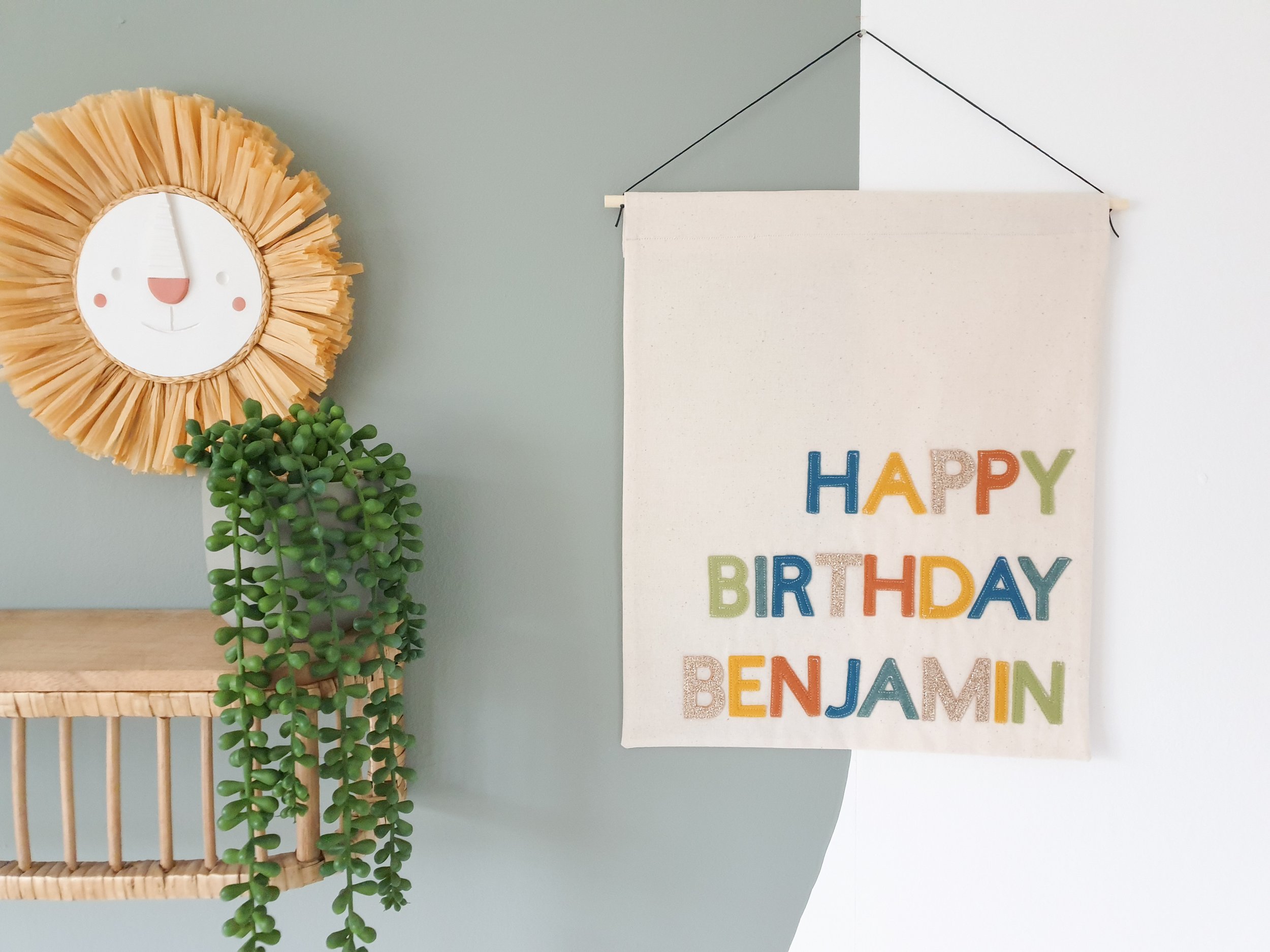 Handmade personalised birthday banner hanging in children's room.