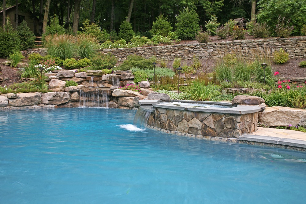 Inground pool with water feature in Saddle River, NJ