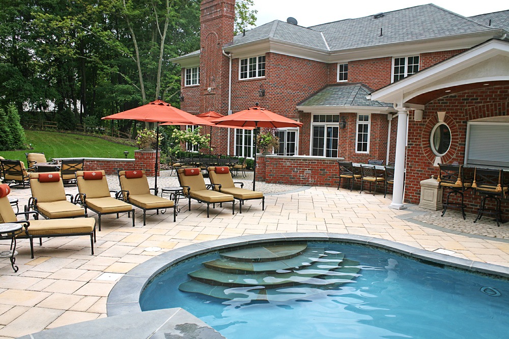 Concrete inground pool and paver patio in Saddle River, NJ