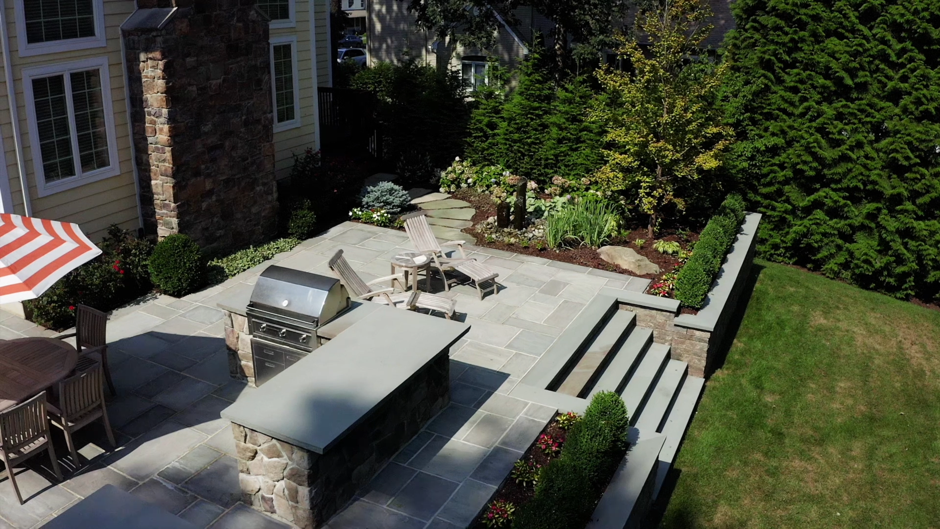 Landscape design with paver patio and outdoor kitchen in Wyckoff, NJ