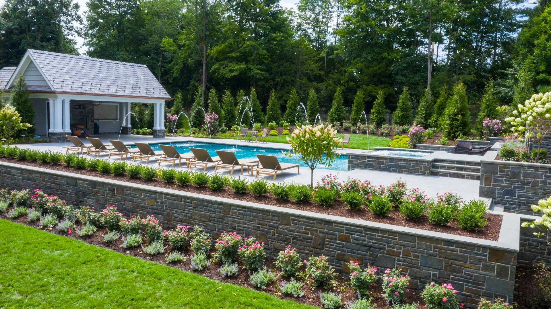 Landscape design with retaining wall and plantings in Saddle River, NJ
