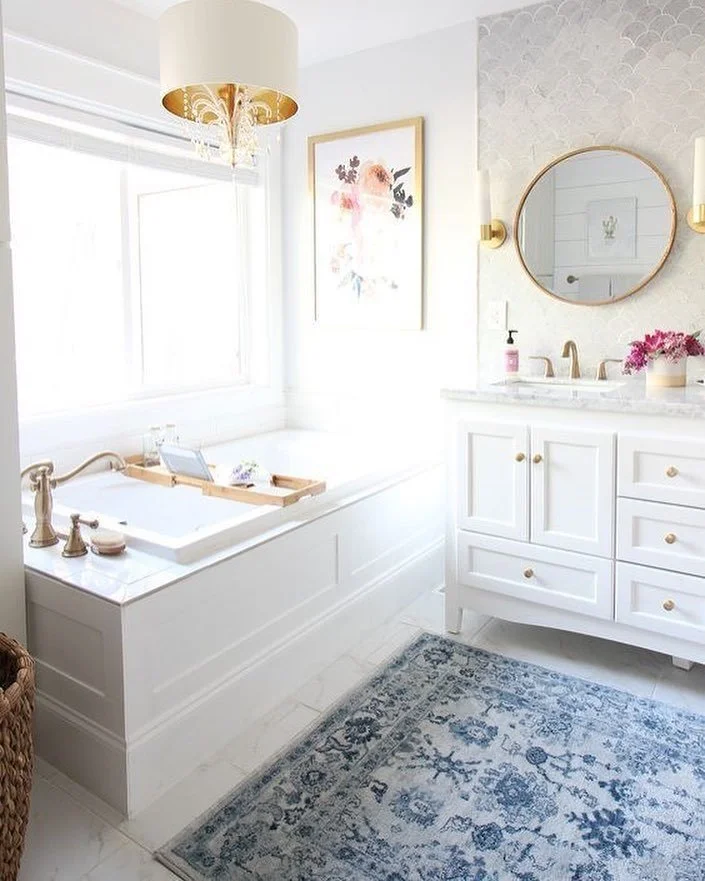 Don&rsquo;t forget to warm up your favorite spaces by laying texture and adding pops of color. This rug completes this beautiful bathroom! 💙 
#homeredefined#bathroominspo#bathroomdecor#batgroomdesign#bathroomdesign#rusticdecor#whitecabinets