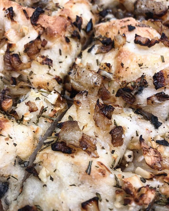 A close-up of our Roasted Onion &amp; Herb Focaccia available today by the slice!