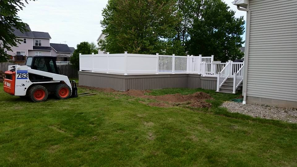 Heavy machinery is being used on a new deck in the process of being built.