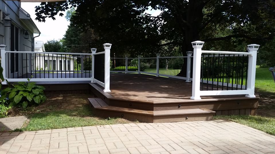 Hexagonal steps lead up to a dark deck with white and black fencing.