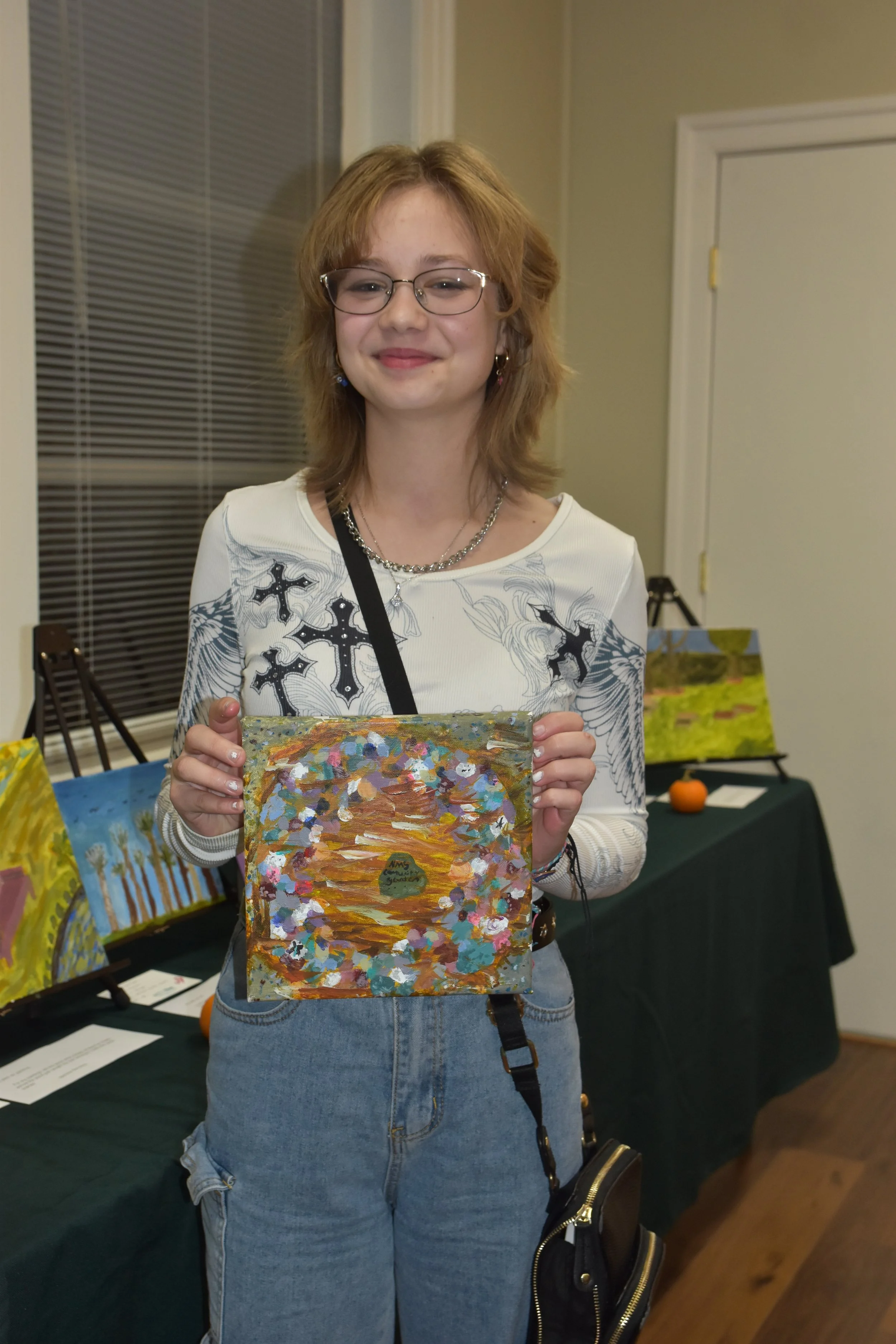 Arianna Donahoe with her painting "Rocky Rainbow"