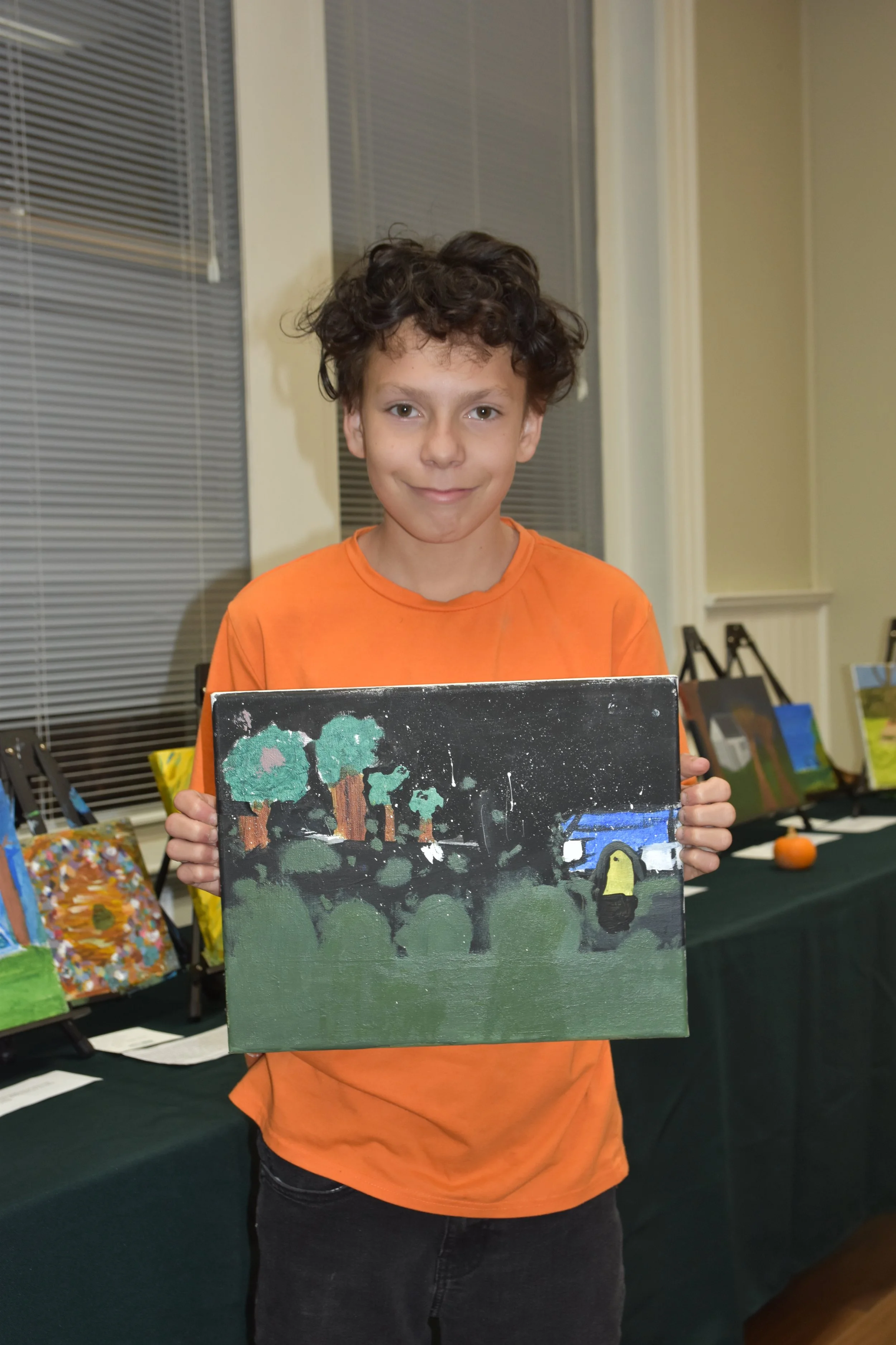 Mikeal Martinez Shipe with his painting "NMS at Night"