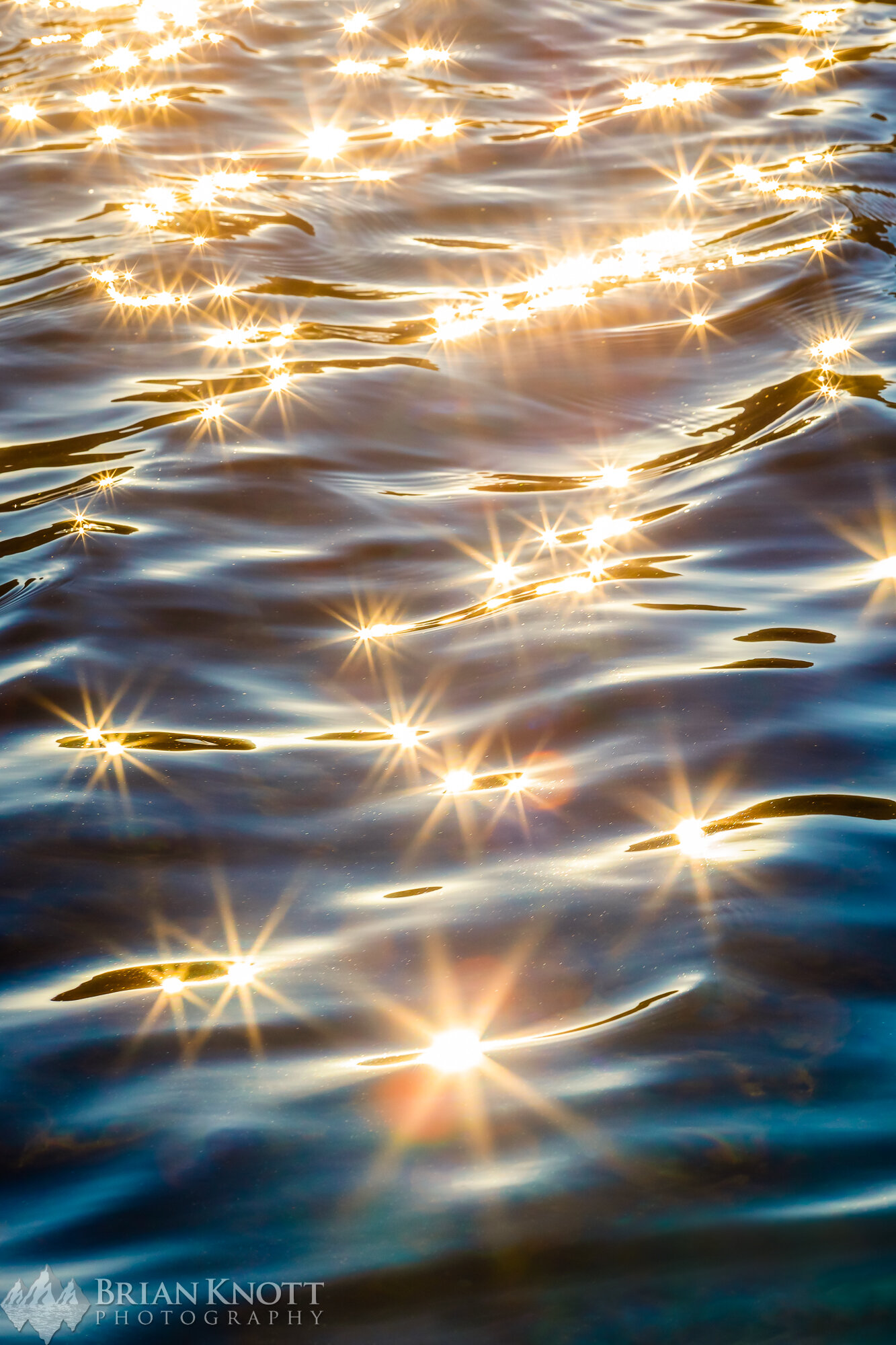 Sunbursts in a high Sierra lake.