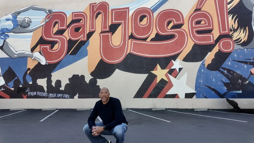 Coach Mike Allen in front of the San Jose mural