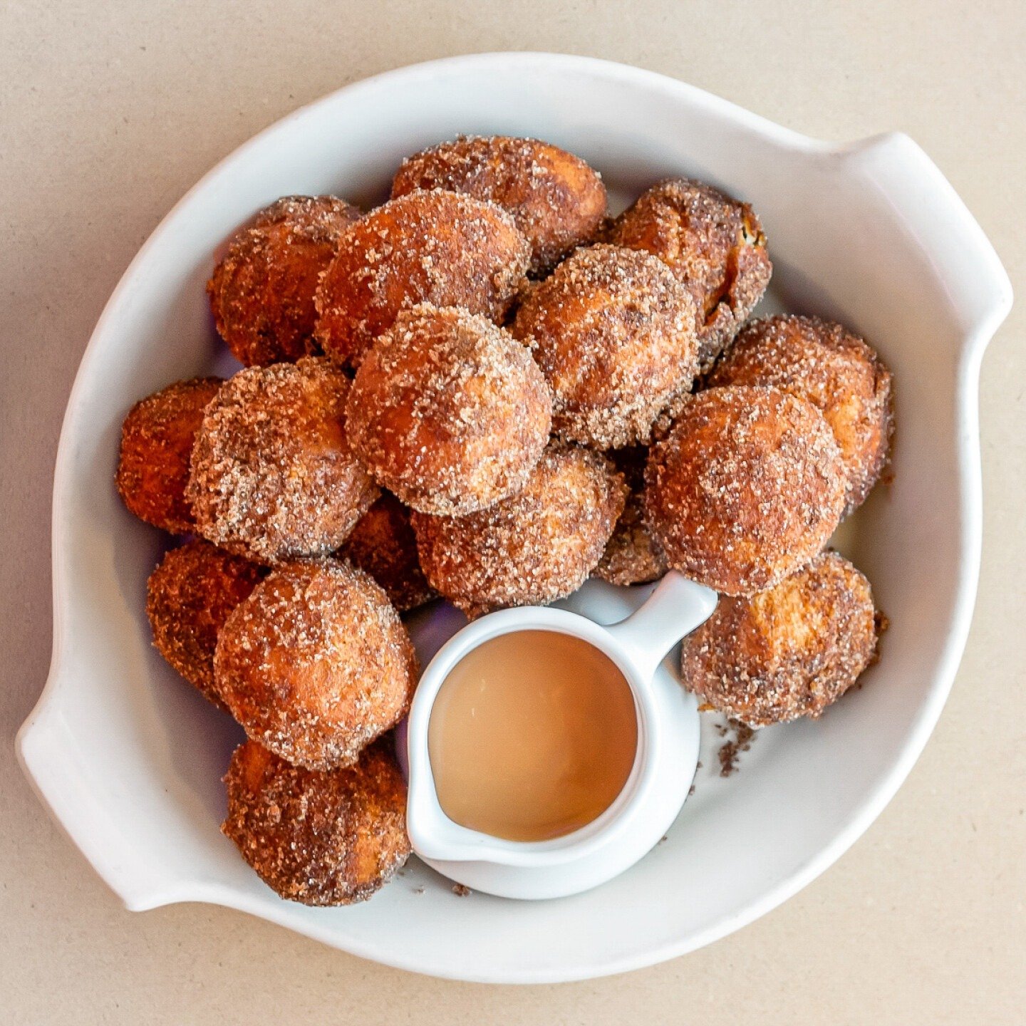 Our donut holes are the perfect all day treat - hot &lsquo;n&rsquo; fresh, tossed in cinnamon sugar &amp; served with caramel sauce 😍