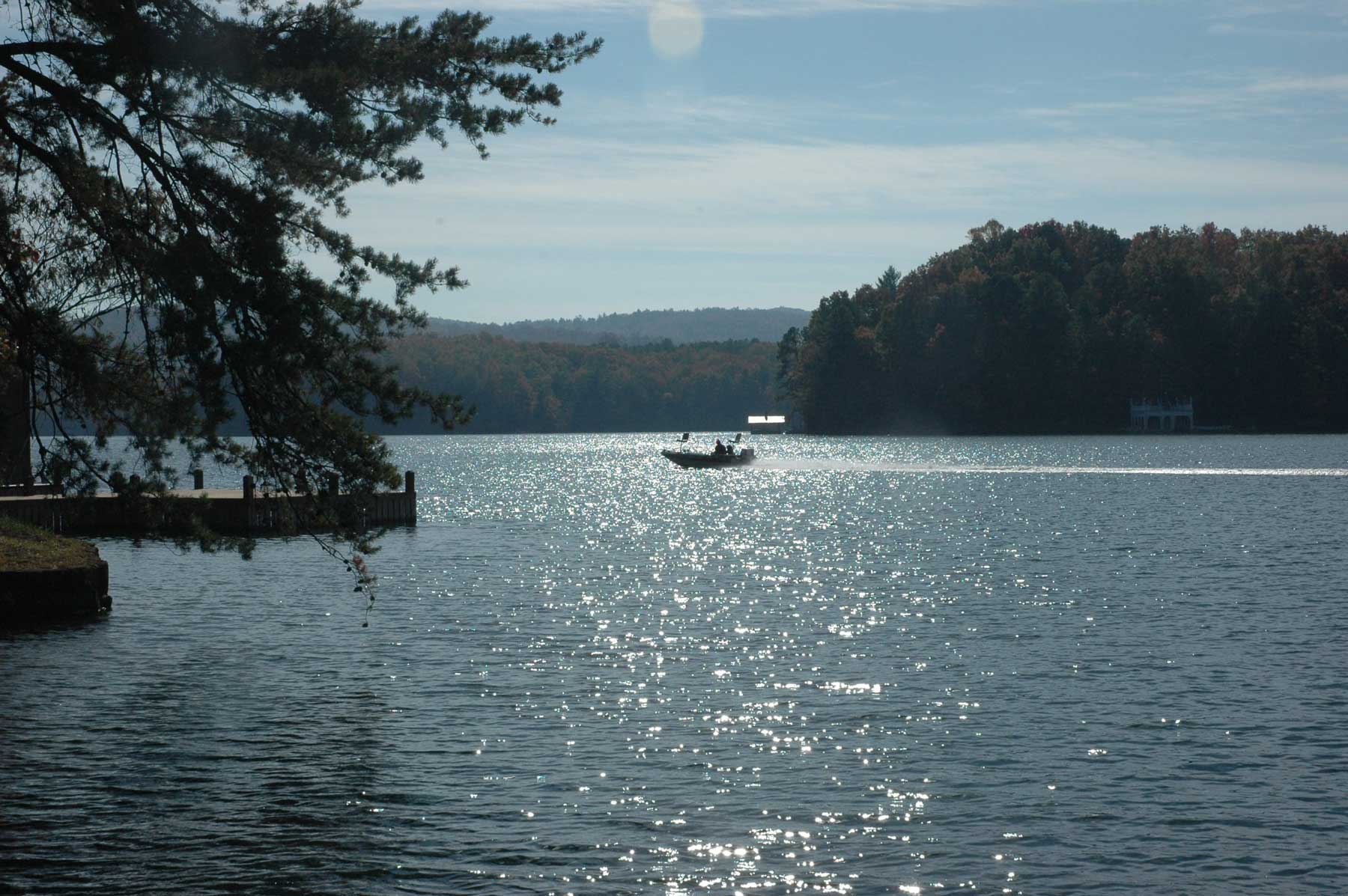 Boat on Lake Burton with trees and mountains 